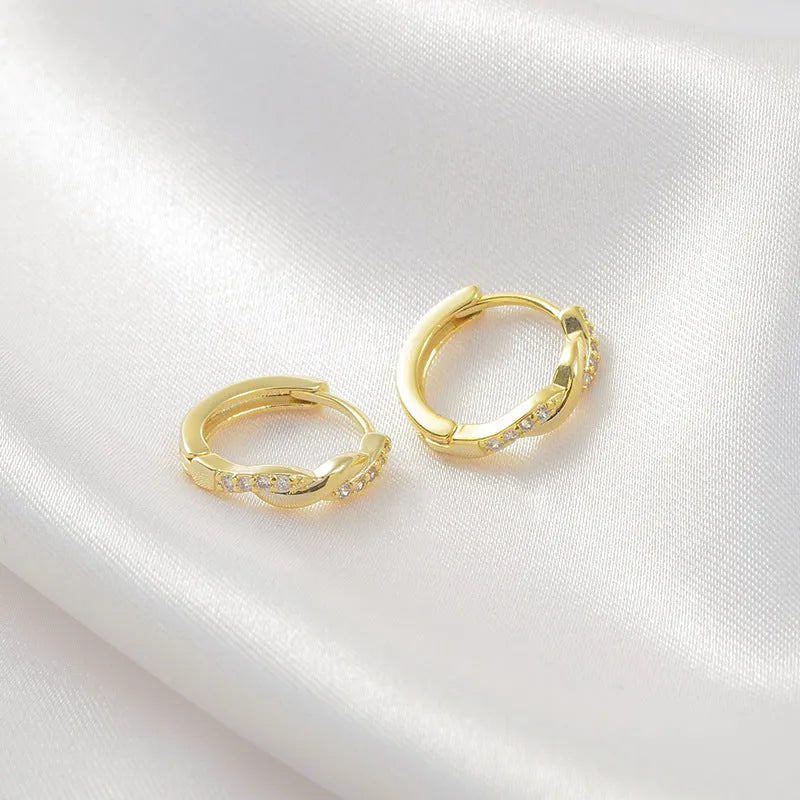 Gold geometric interwoven hemp rope earclip earrings on a white background