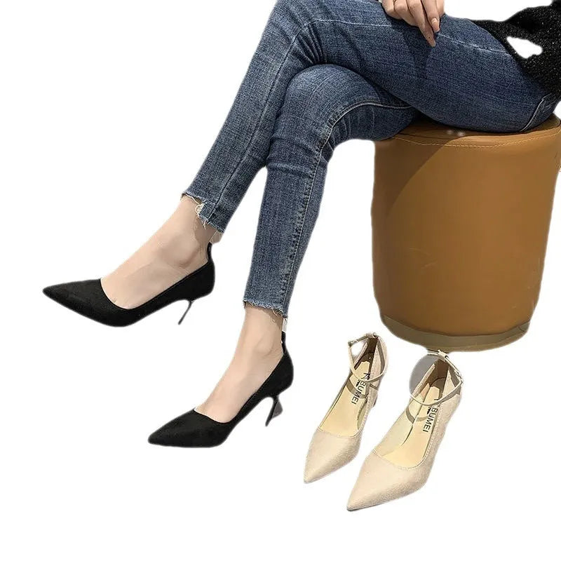 Black women's stiletto heel pumps with a skull pattern and buckle detail on a white background.
