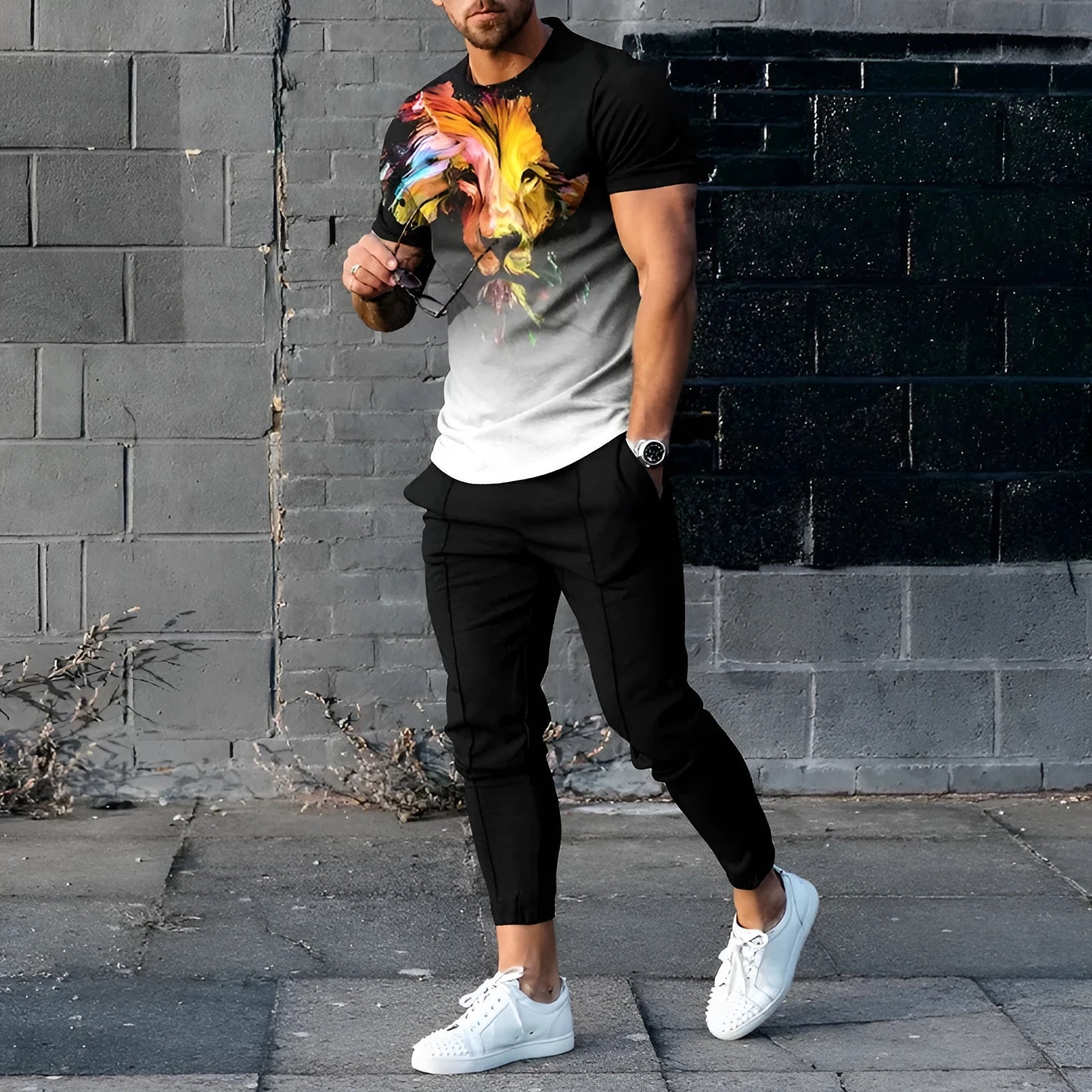 Men's short-sleeved printed pullover suit set with round neck T-shirt and matching trousers on a hanger.