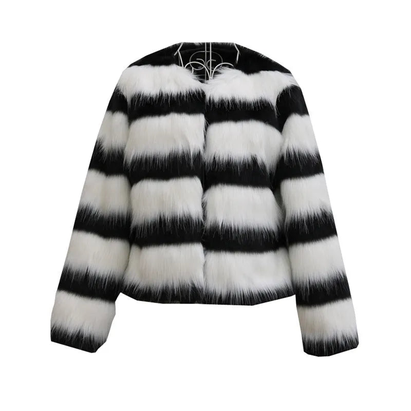 Womens black and white striped faux fur leather jacket with long sleeves on a model.
