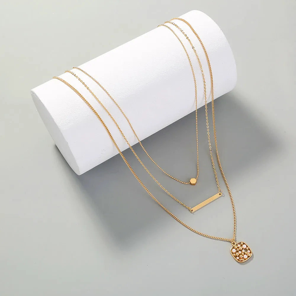 Multi-layer gold necklace with geometric pineapple pendant on adjustable chain, electroplated finish, zinc alloy
