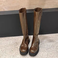 Women's black knee-high round toe boots with a chunky heel and back zipper on a white background.