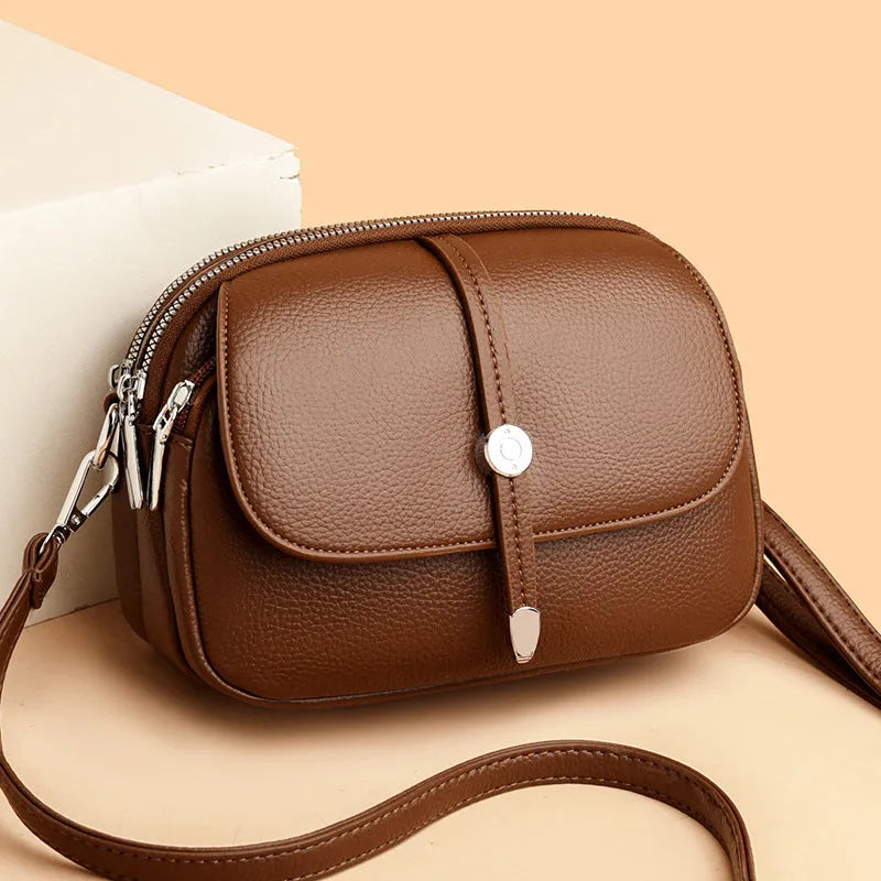 Women's soft PU leather crossbody shoulder bag oval shape in black khaki dark brown colours