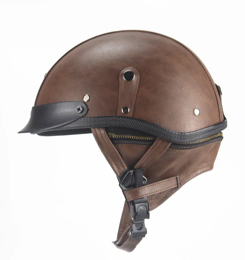Retro black leather motorcycle helmet with a half-visor on a background.