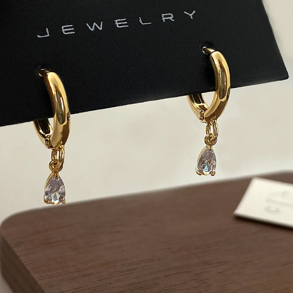 Women's zircon necklace, earrings, and anklet set with geometric pendant on a regular chain.