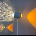Modern Sunset Red floor lamp projecting a water wave light pattern onto a floor.