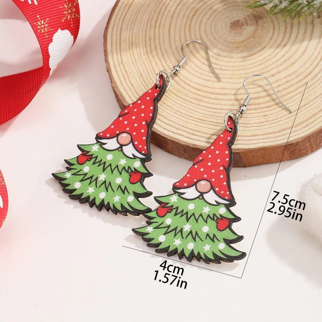 Wooden geometric Christmas earrings with printed festive designs on a white background.