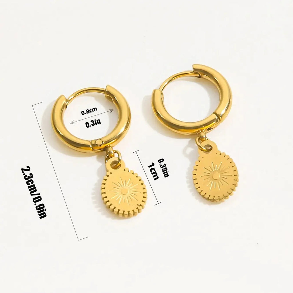 A pair of stainless steel geometric earrings with ellipse design details on a white background.