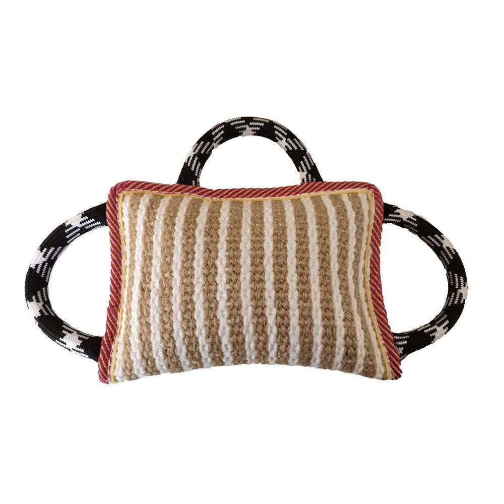 Dog tug of war toy with blue jute bite pillow and three rope handles on a wooden floor.