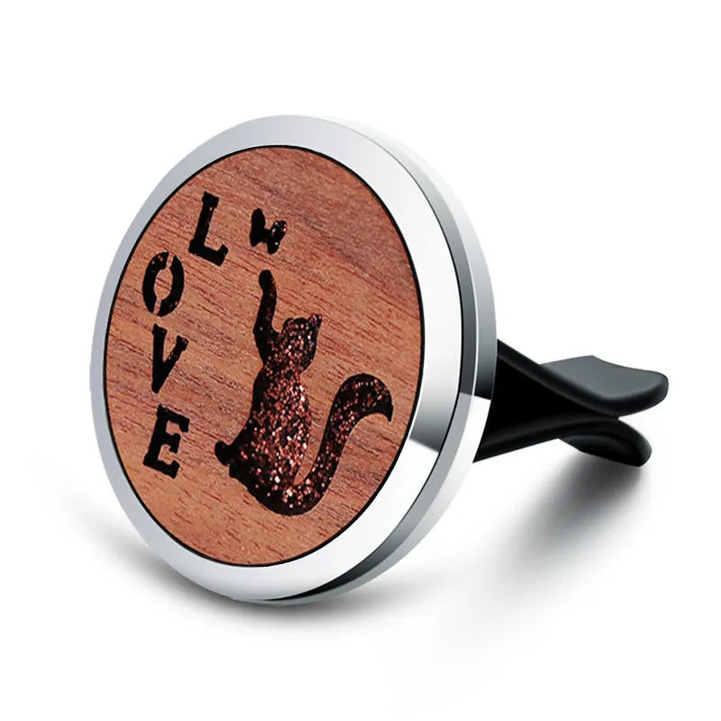 Round car vent aromatherapy clip in alloy wood construction showing hollow centre for incense