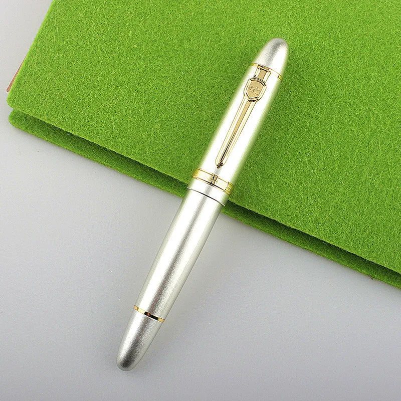Metal ball pen with pearl beads, black body and silver clip, lying on a desk