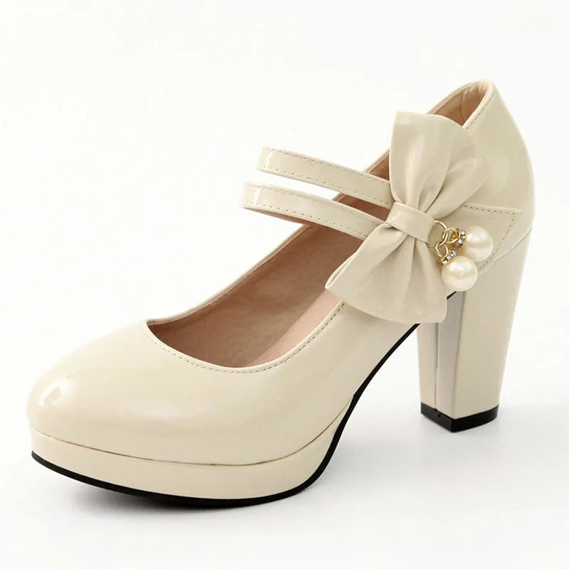 Red platform shoes with a thick chunky heel, round toe, and buckle fastening on a white background.