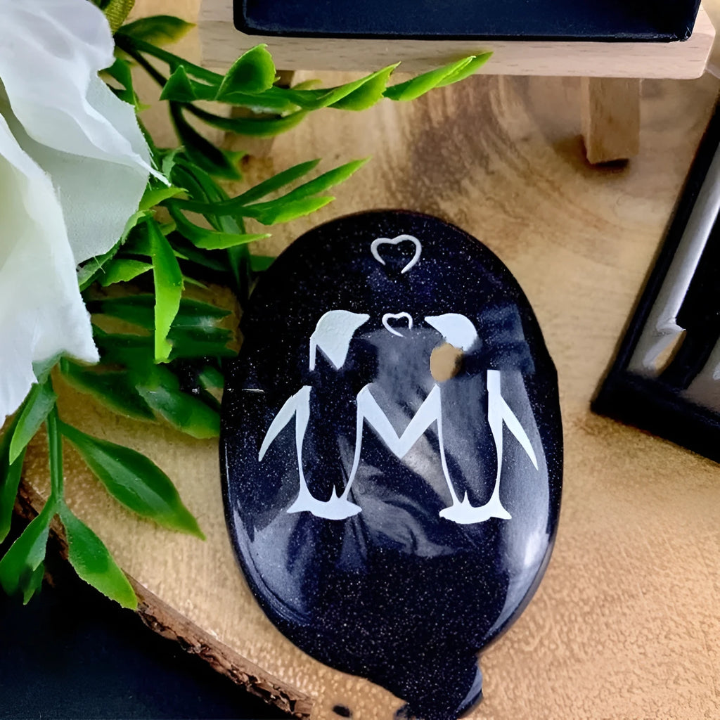 Black penguin glass pendant love token ornament 4x3cm and 6x4cm sizes on a white background