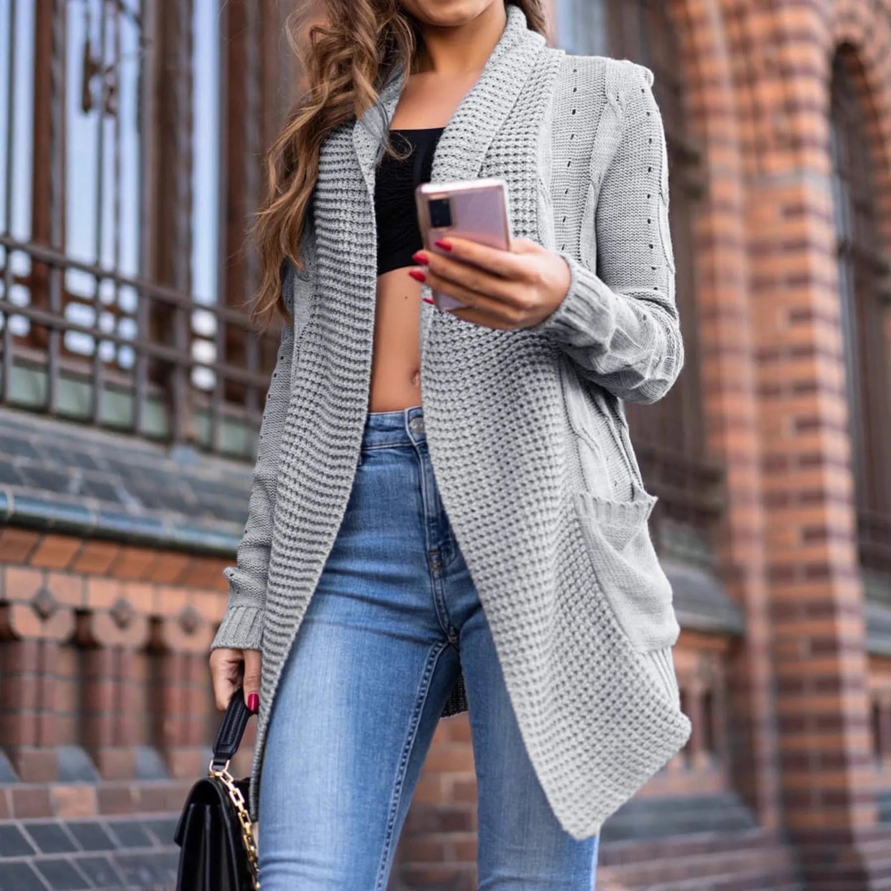 Women's loose fit grey cardigan coat with front pockets showing 65cm medium length