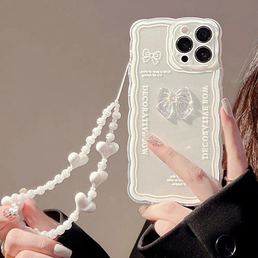 Transparent iPhone case with a 3D ice-through bow on the back and a white love lanyard.