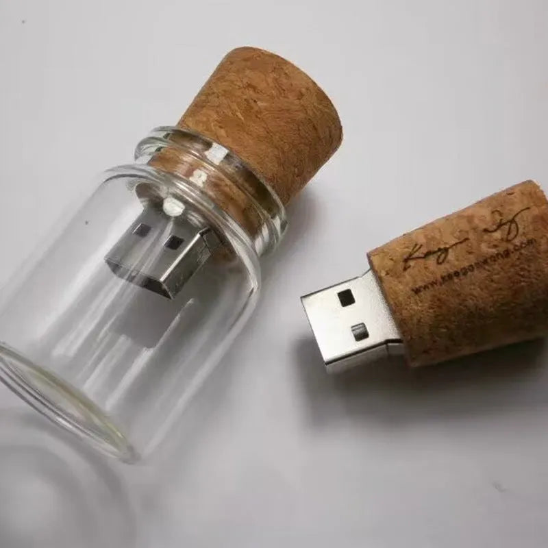 Transparent bottle-shaped USB flash drive with a wooden charm inside, showing metal connector.