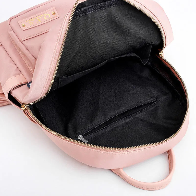 Black casual nylon backpack with shoulder straps, showing internal organiSation pockets and a soft handle.