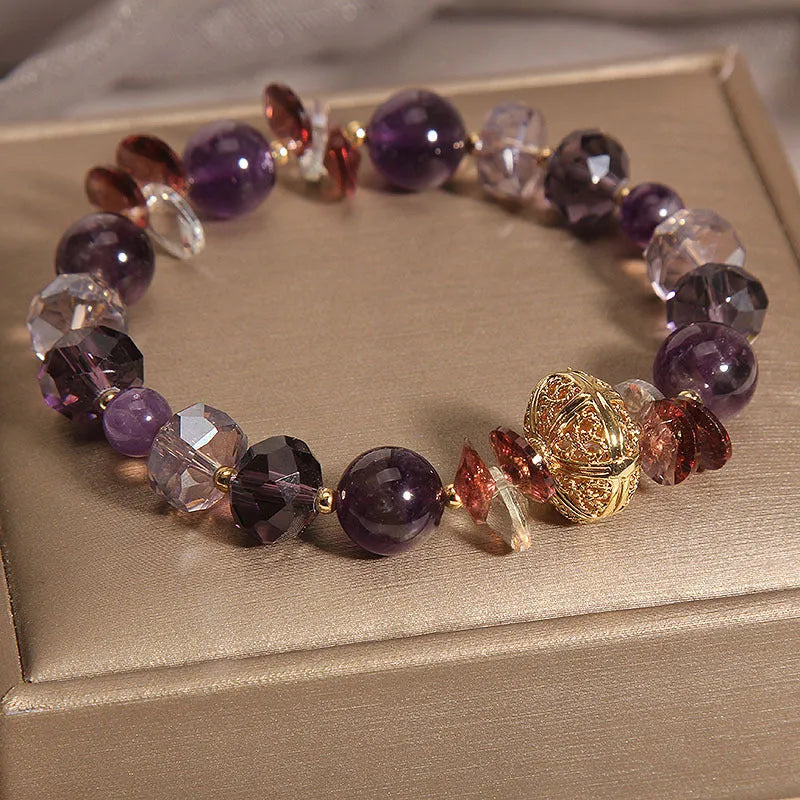 Purple crystal bracelet with pumpkin-shaped beads and rhinestone accents on a wrist.