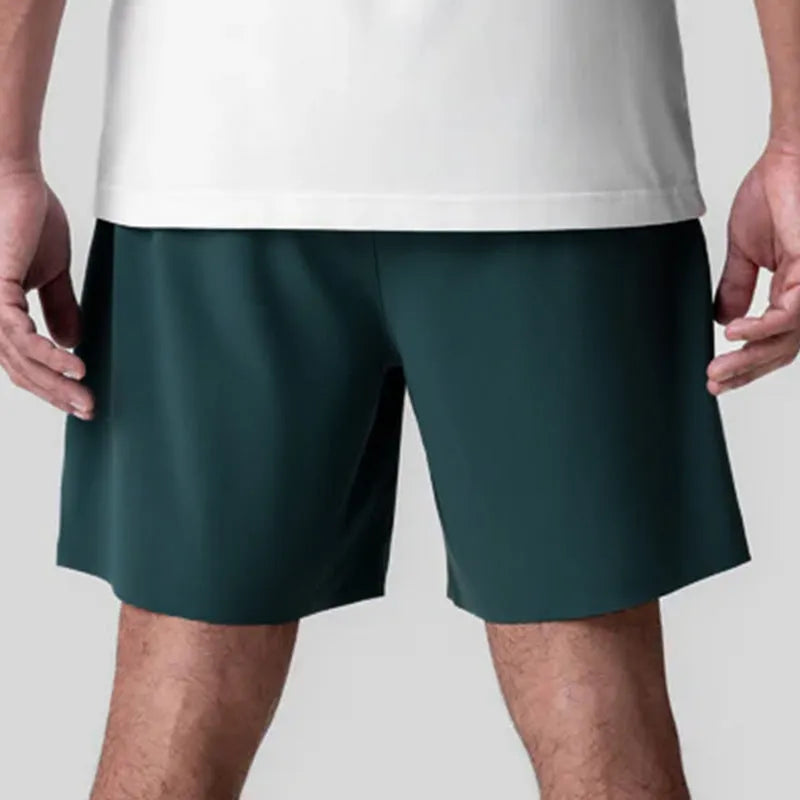 Men's grey seamless polyester sports shorts with elastic waist, shown front and back.