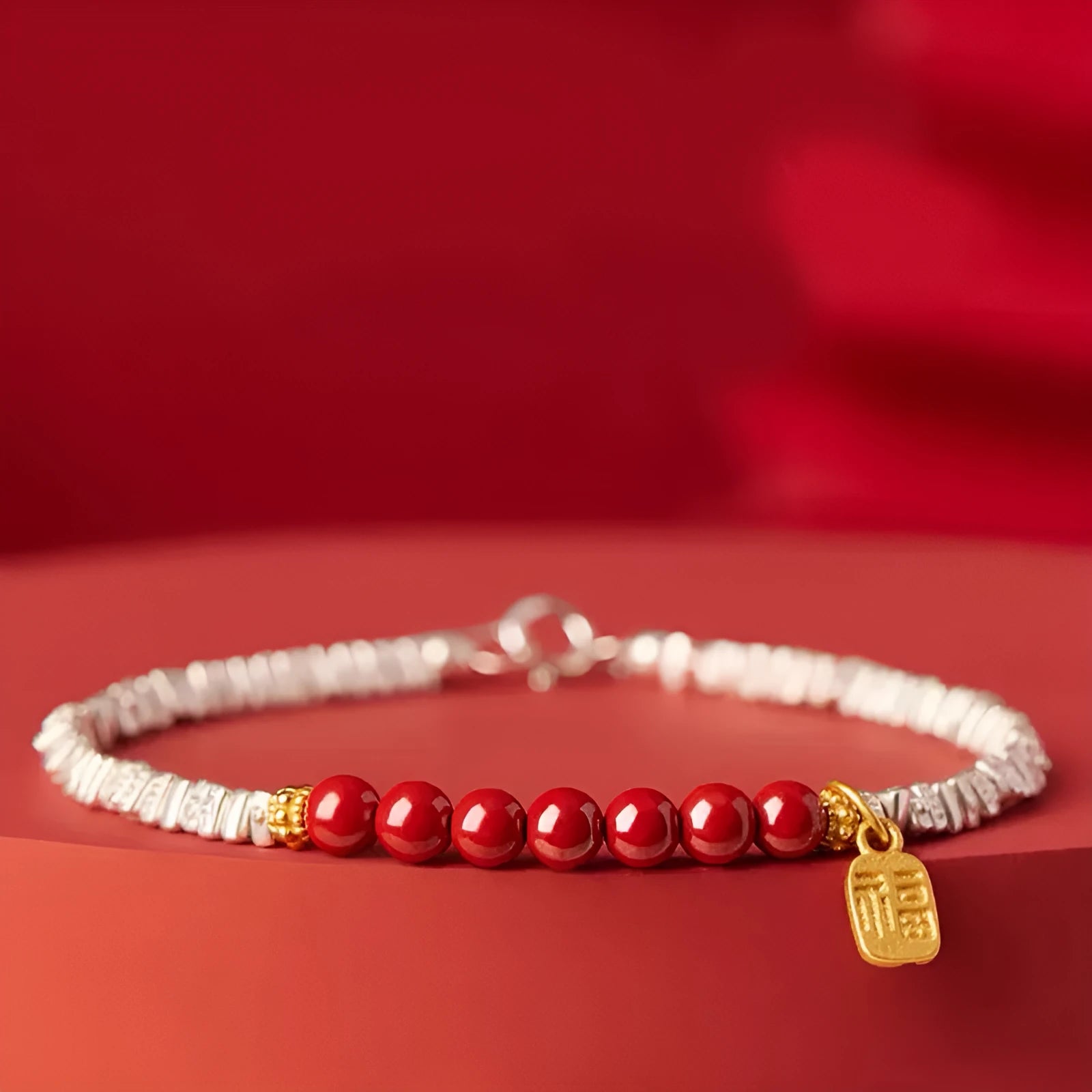 Silver-toned couple bracelet with geometric charm and round beads on white background