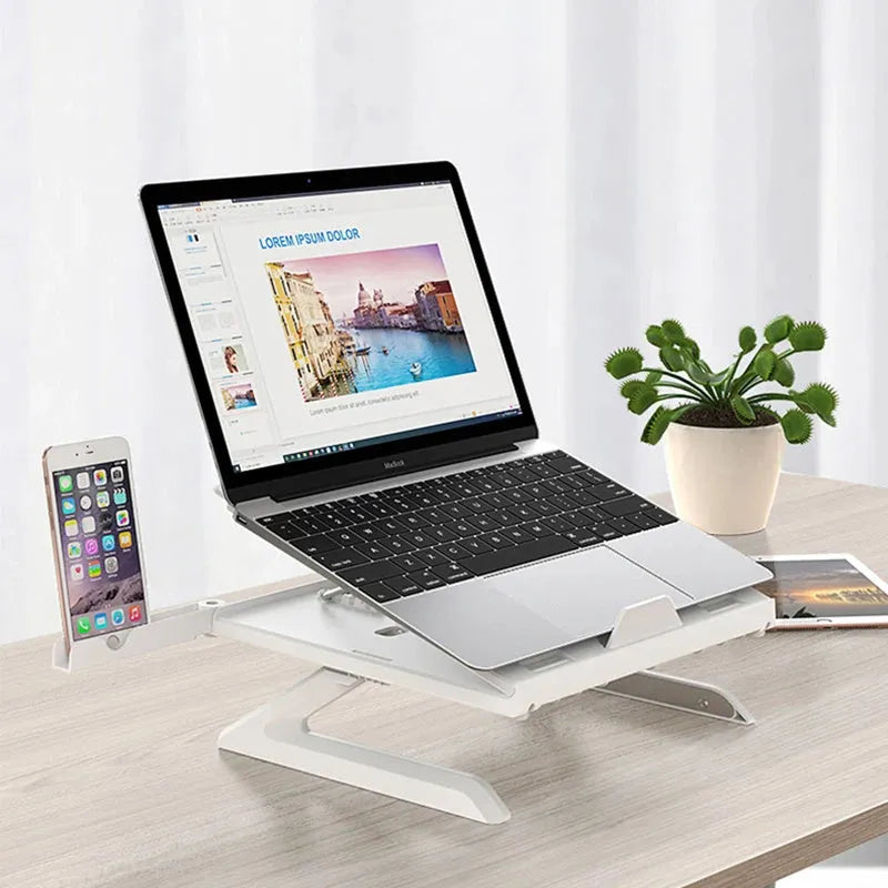 Black folding aluminium laptop stand with 9-level angle adjustment and cooling slot, on a desk with a laptop