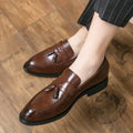 Men's black slip-on loafers with a tassel decoration on a pointed-toe, low-top artificial PU upper.