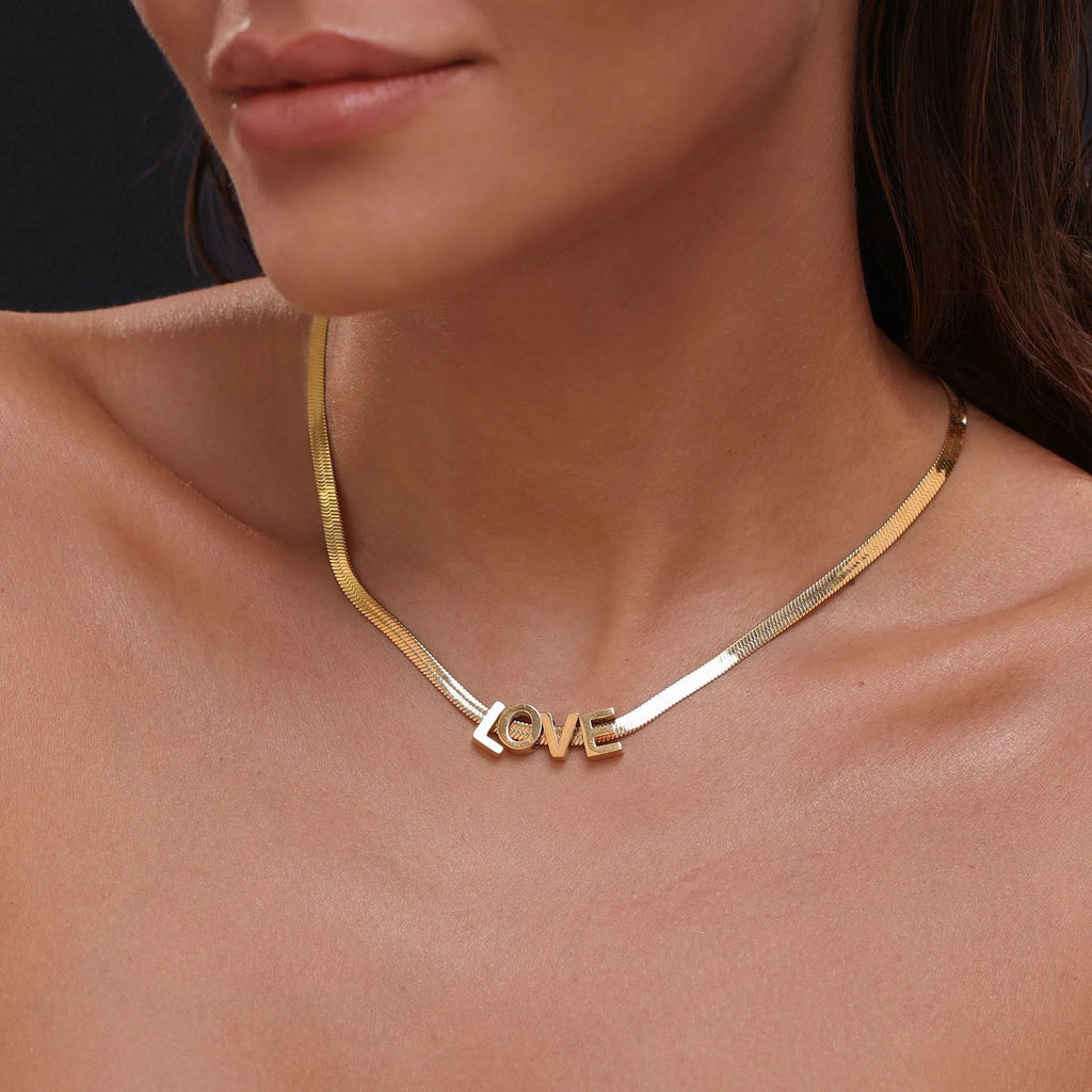 Titanium steel necklace with a personalised letter charm on a 40.5cm gold electroplated chain.