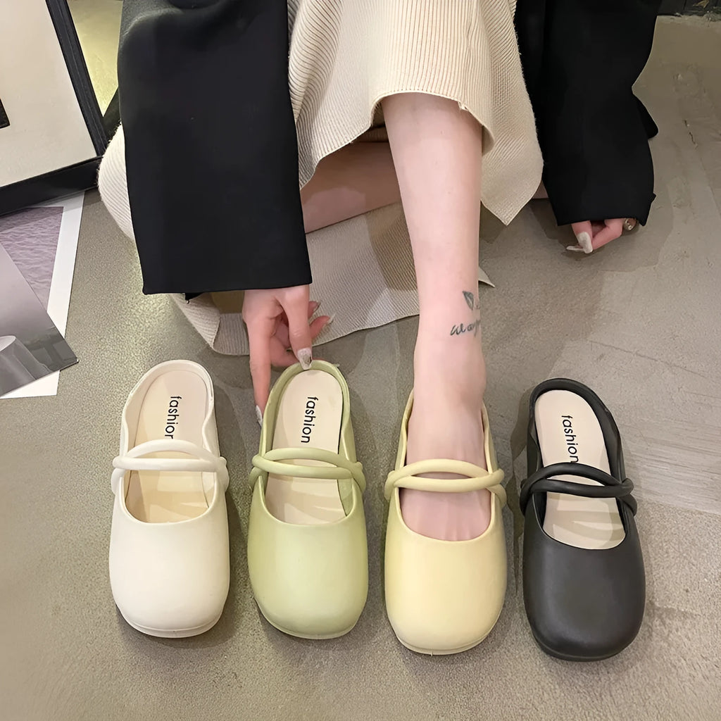 Women's black plastic toe cap flip-flop sandals on a white background.