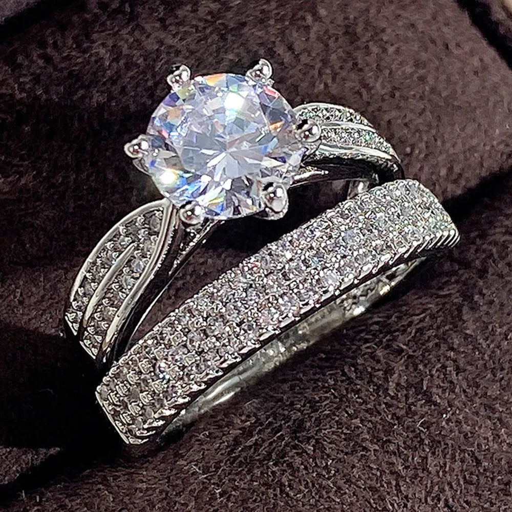 Geometric white gold colour alloy ring and bracelet combined into one continuous piece on a model's hand.