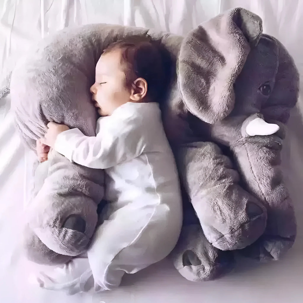 Soft grey elephant plush toy pillowcase for a child's bed.