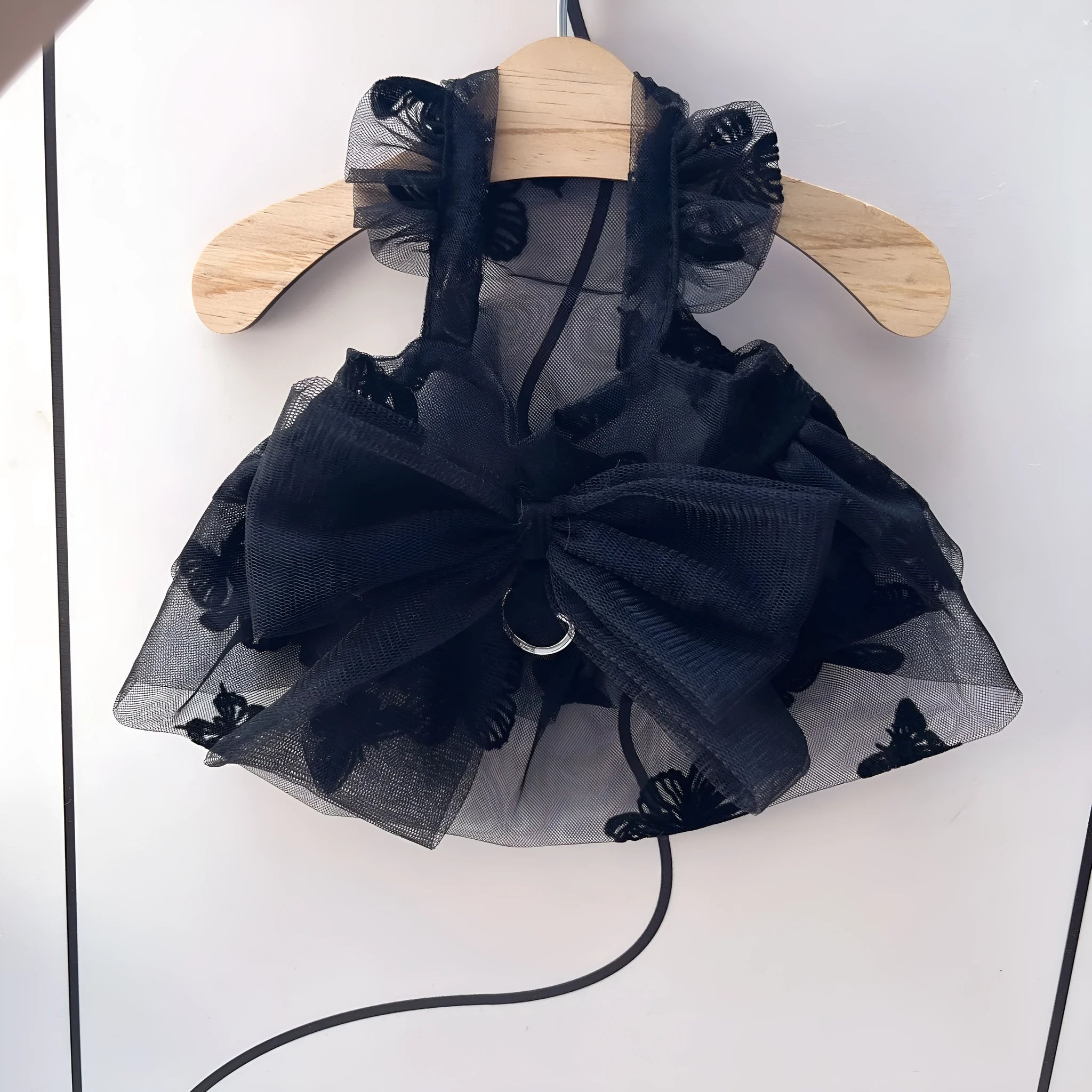 Black layered tulle princess skirt on a small dog, showing chest fit and full skirt silhouette.