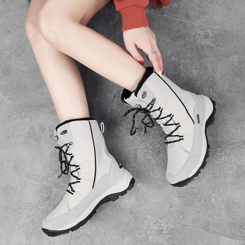 Women's black genuine leather mid-calf snow boots with a rubber sole on a white background.