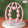 Handheld 12-wheel leg massage roller in macaron pink colour on a white background.
