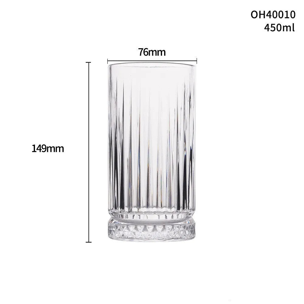 Clear crystal whiskey shot glass with thick bottom base on a table.