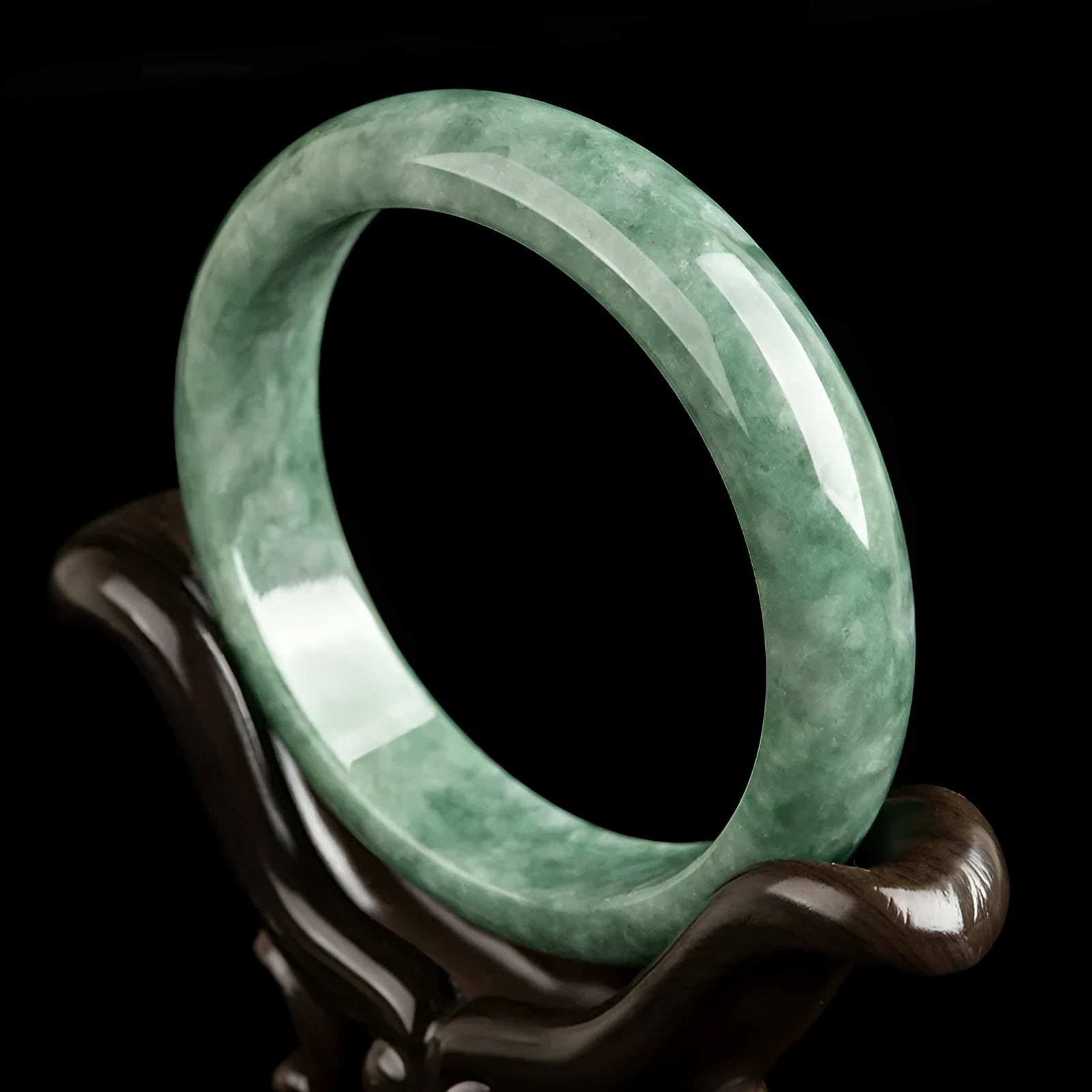 Natural emerald bean green women's bracelet on a gift box, showing simple design and deep pea green stone colour.