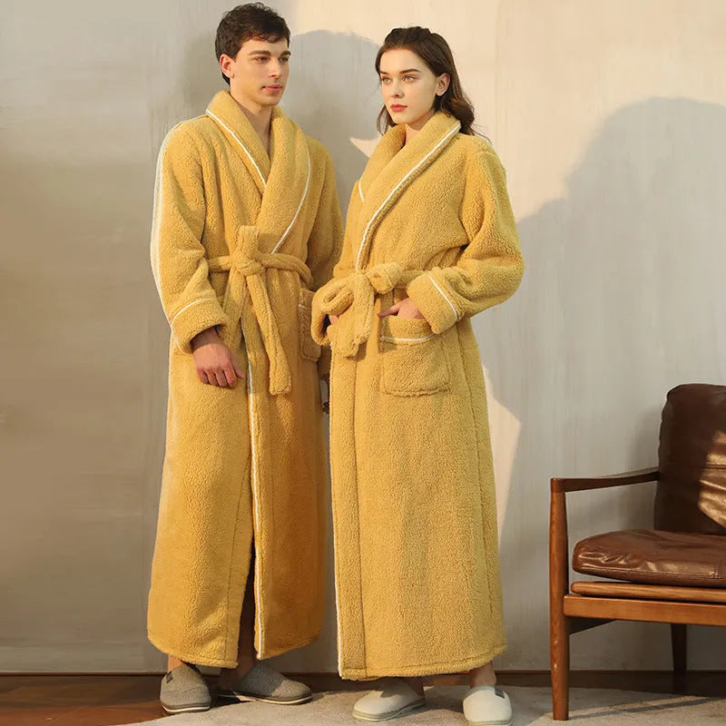 Man and woman wearing matching thick navy blue flannel bathrobes, showcasing the extended length and winter fabric.