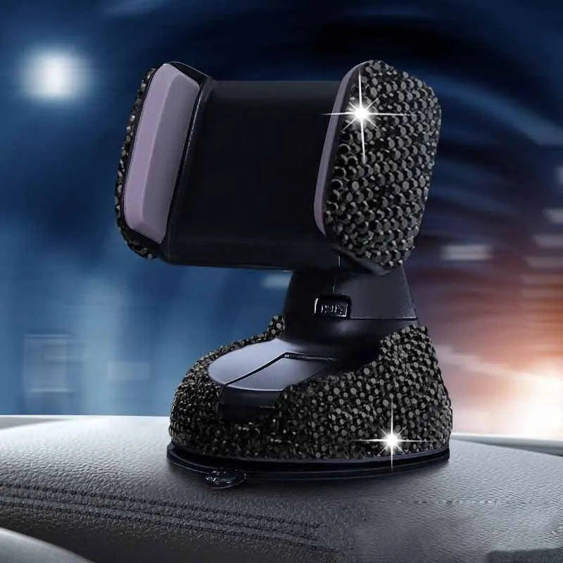Diamond-encrusted car phone holder mounted on air vent with adjustable push-button mechanism and smartphone securely held