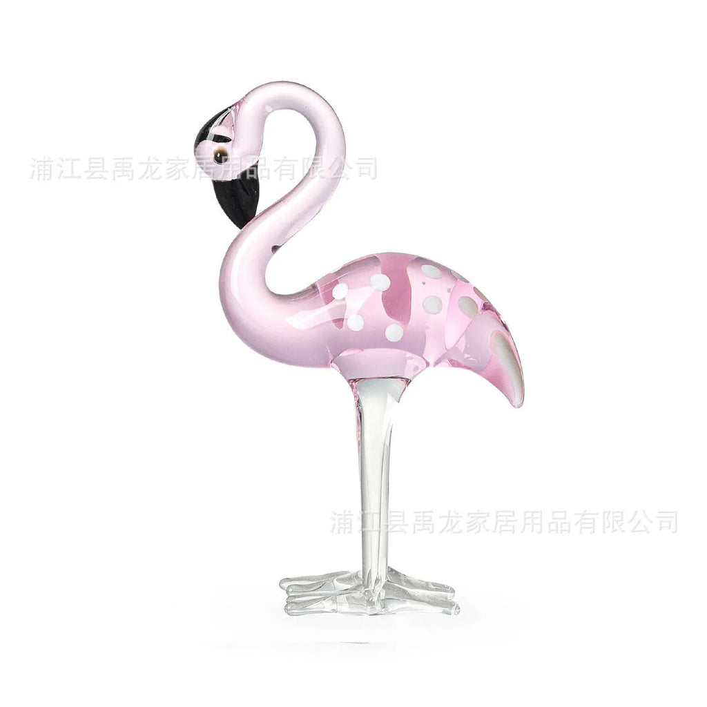 Pink flamingo decorative ornament made of white crystal on a table.