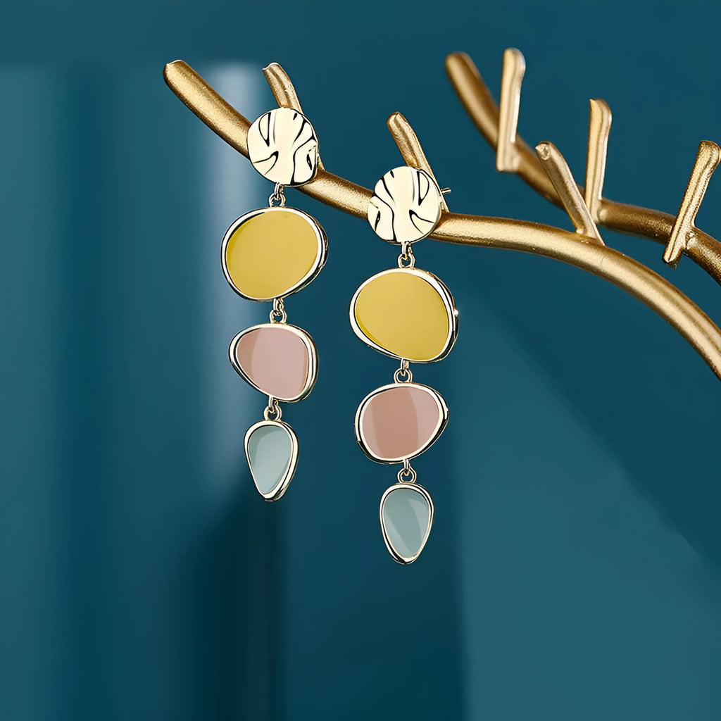 A pair of simple vintage wafer earrings in Morandi colours with a sterling silver needle post.