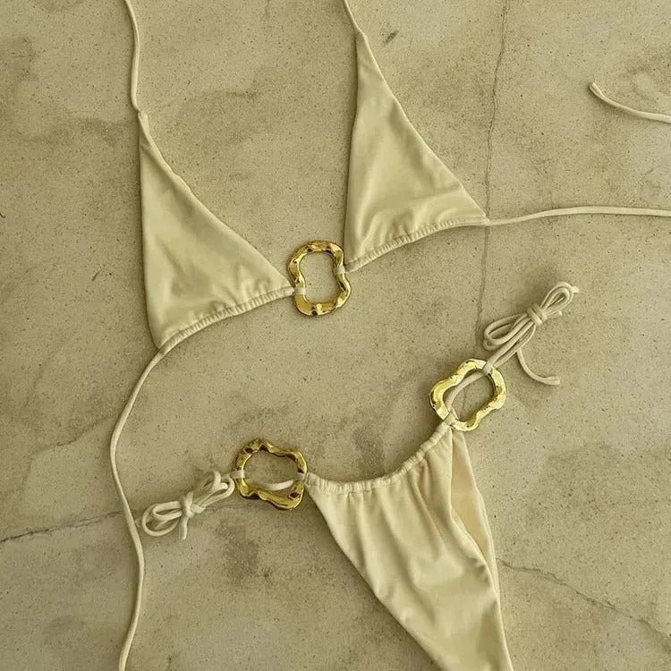 Women's halter neck bikini set with lace-up front on the top and low waist briefs in a solid colour.