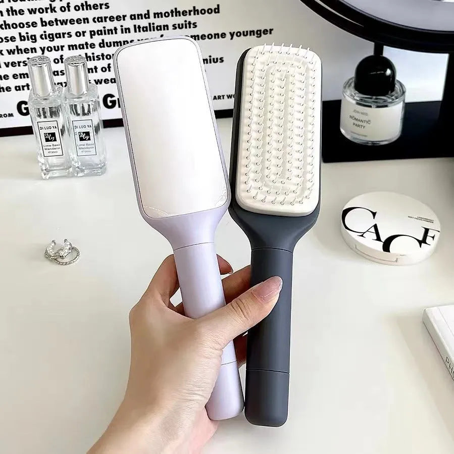 Roland purple self-cleaning hair brush with rotating telescopic handle and anti-static bristles.