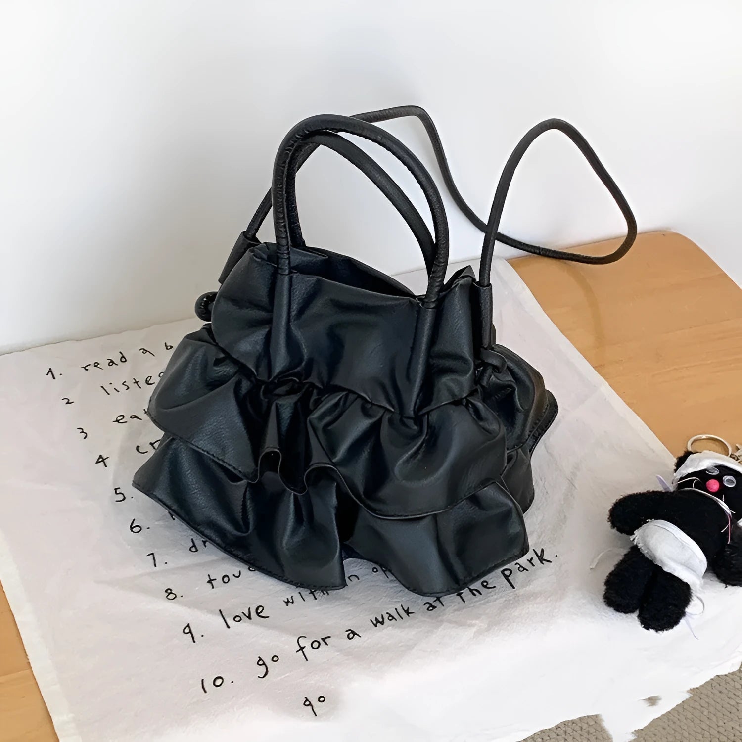 Bucket style PU folding shoulder bag in beige with open pocket for daily commute