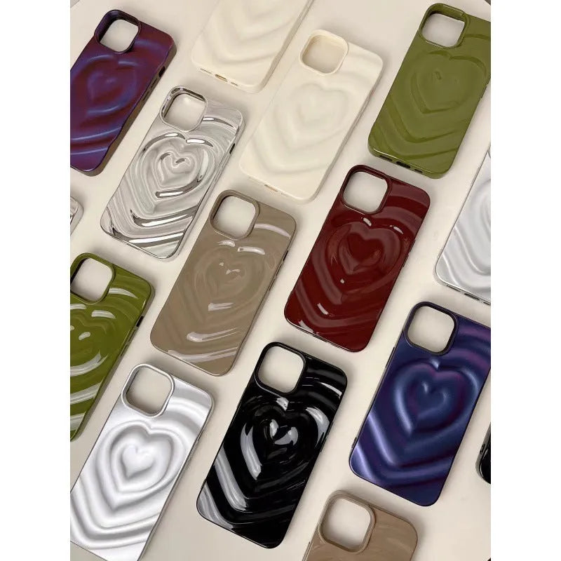 Solid colour iPhone case with a raised 3D love heart design, shown in bright purple.