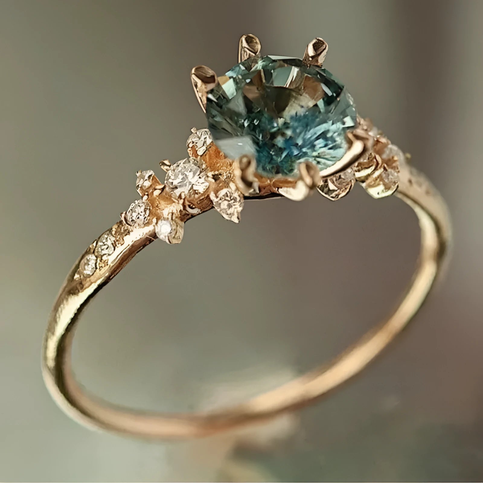 Gold plated geometric ring with claw inlaid zircon stone and chamfered square pattern.