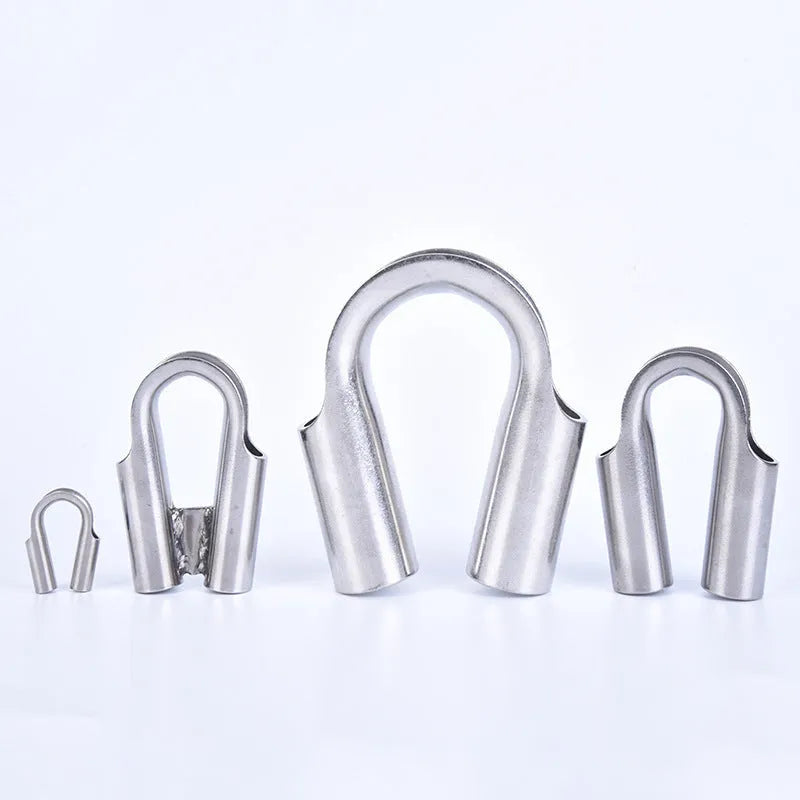 Set of stainless steel tubular chicken heart sleeve rings in various sizes on a workbench.