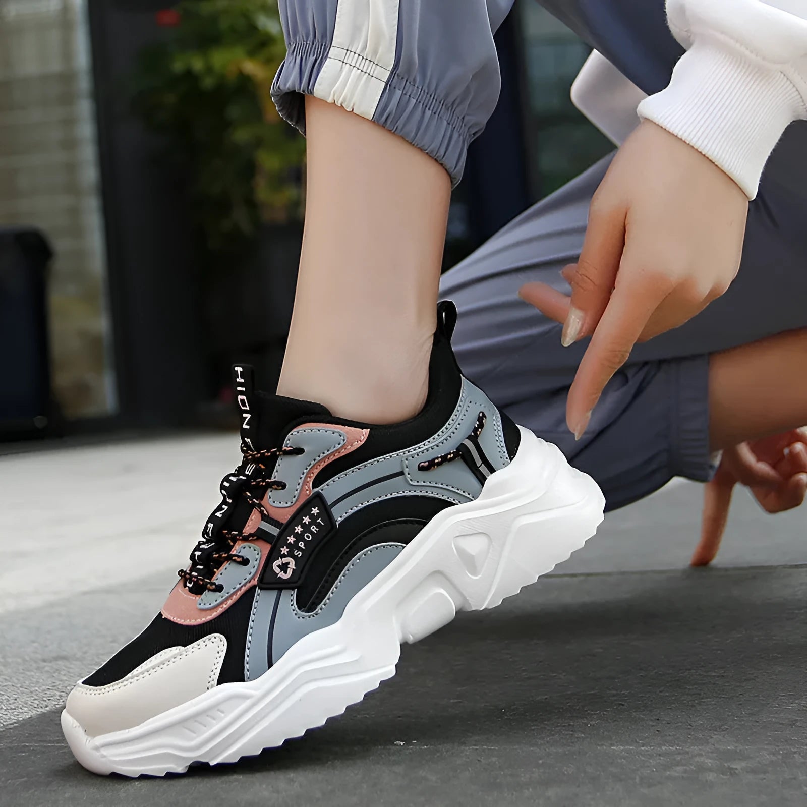Women's white casual sports shoes with mesh upper, thick PU sole, and buckle detail