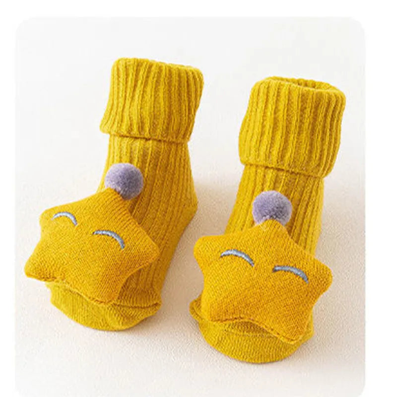 Cotton baby floor socks in assorted colours and prints like blue bow and pink stars on a size chart.