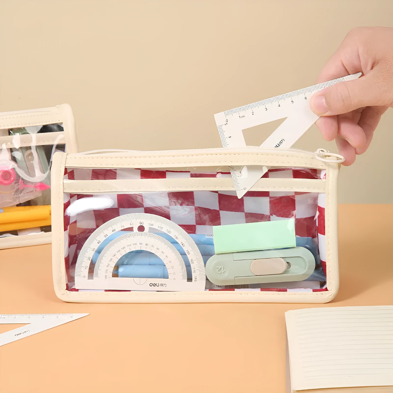 Clear PVC pencil case with chessboard pattern showing pens inside