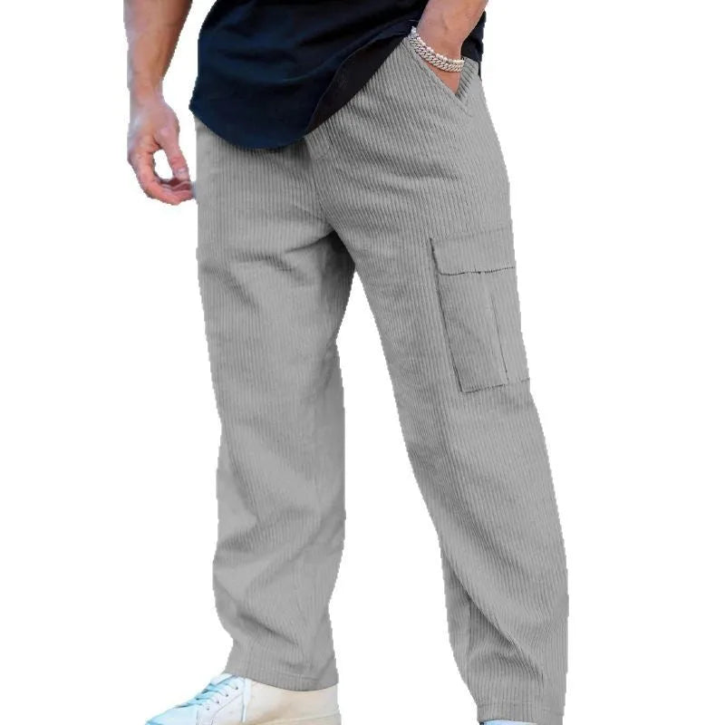 Men's navy blue corduroy cargo trousers with a drawstring waist and straight wide-leg cut on a hanger.