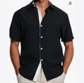 Men's short-sleeved floral print shirt in lightweight polyester fabric on a hanger.